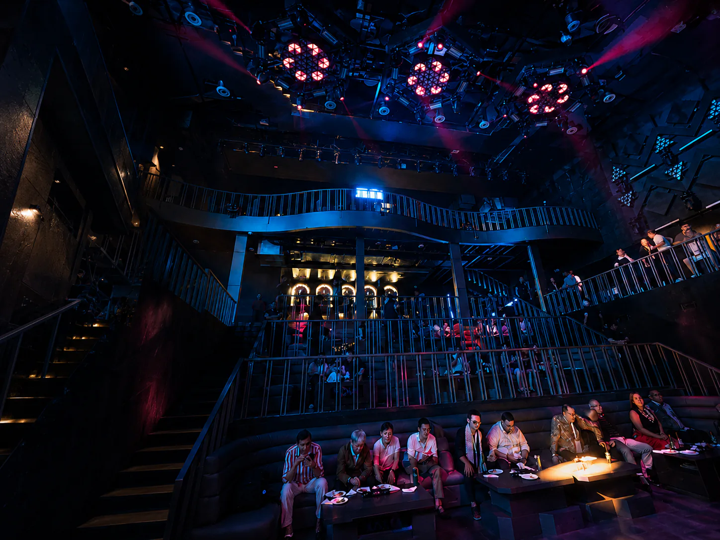 Club Nova's tiered VIP seating and balcony under blue and red lighting